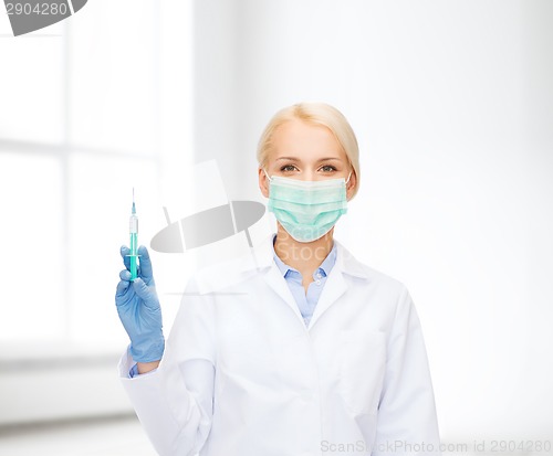 Image of doctor in mask holding syringe with injection