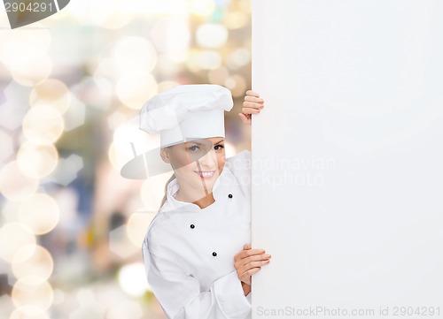 Image of smiling female chef with white blank board