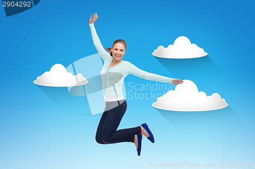 Image of smiling young woman jumping in air