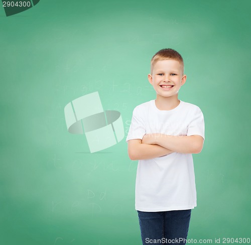 Image of little boy in white t-shirt with arms crossed