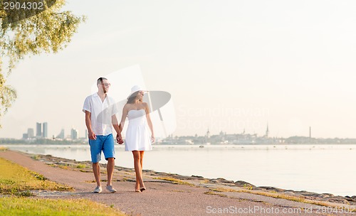 Image of smiling couple walking outdoors