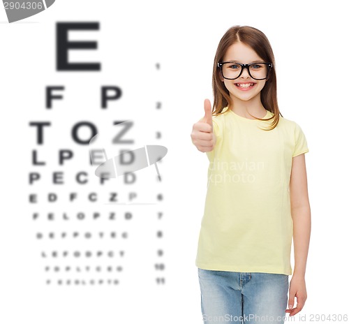 Image of smiling cute little girl in black eyeglasses