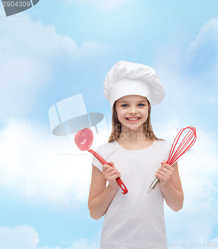 Image of smiling girl in cook hat with ladle and whisk