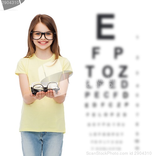 Image of smiling cute little girl in black eyeglasses