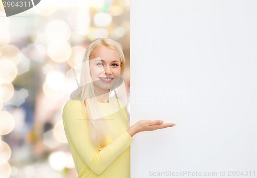 Image of smiling woman in sweater with blank white board