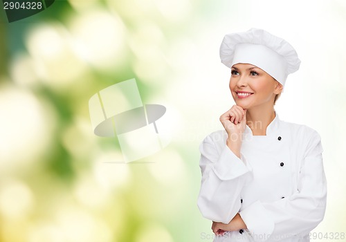 Image of smiling female chef dreaming