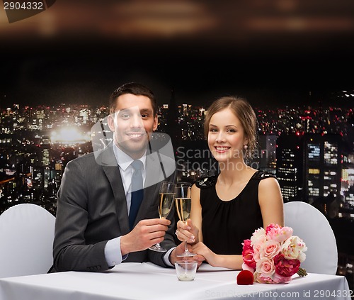 Image of couple with glasses of champagne at restaurant