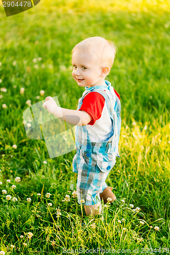 Image of Little Boy Child Running On Green Meadow