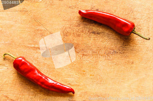 Image of Red Peppers On Old Wooden Table
