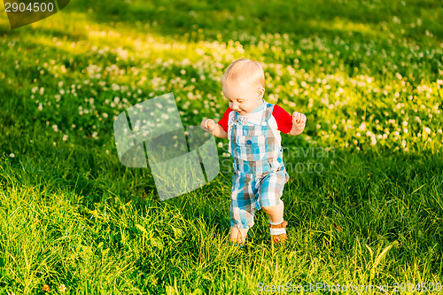 Image of Little Boy Child Running On Green Meadow