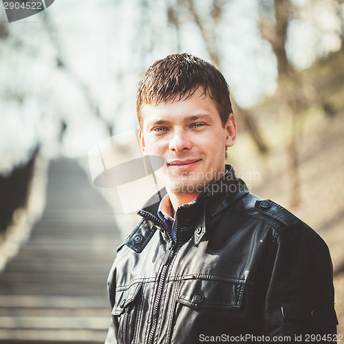 Image of Handsome man outdoors portrait. Autumn colors.