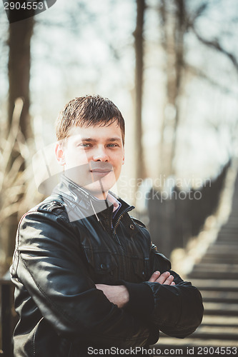 Image of Handsome man outdoors portrait. Autumn colors.
