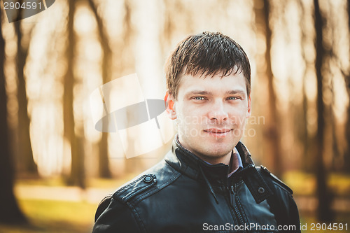 Image of Handsome man outdoors portrait. Autumn colors.