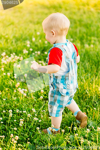 Image of Little Boy Child Running On Green Meadow