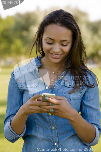 Image of Beautiful woman texting