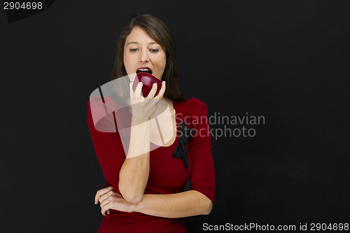 Image of Young woman eating an apple