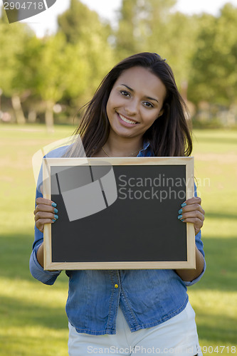 Image of Beautiful woman holding a shalkboard