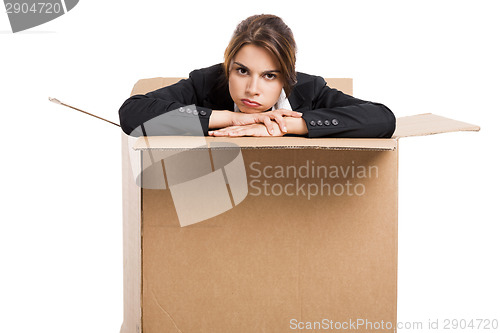 Image of Stressed business woman inside a card box