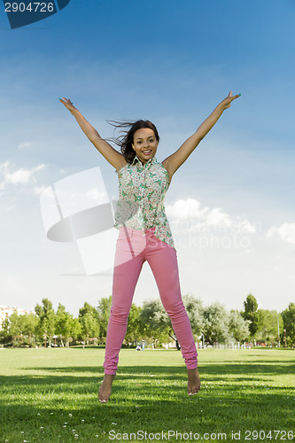 Image of Beautiful African American woman jumping