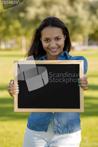 Image of Beautiful woman holding a shalkboard