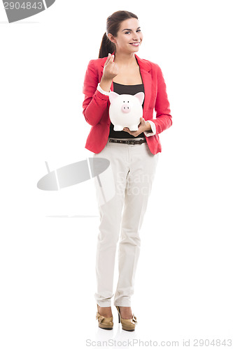 Image of Business woman with a piggy bank