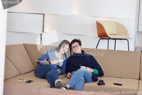 Image of friends with coffee cups enjoying a conversation