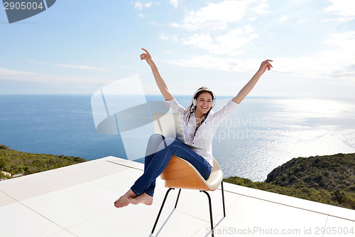 Image of relaxed young woman at home working on laptop