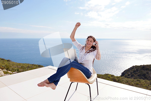Image of relaxed young woman at home working on laptop