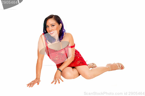 Image of Asian woman sitting on floor.