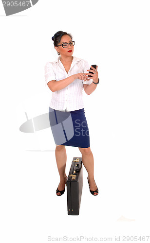 Image of Business women dialling.