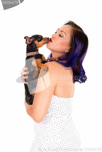 Image of Woman kissing her dog.