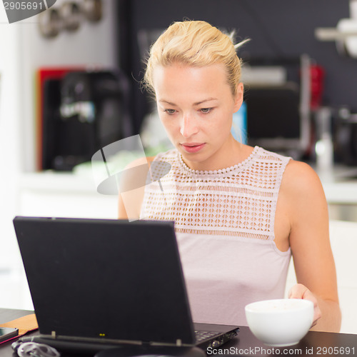 Image of Business woman working from home.