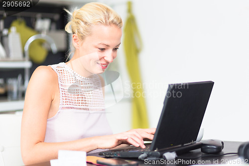 Image of Business woman working from home.