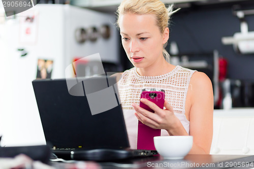 Image of Business woman working from home.