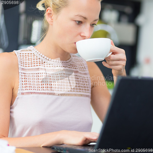 Image of Business woman working from home.