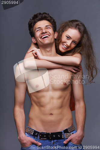 Image of Shirtless young couple embracing