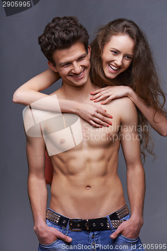 Image of Shirtless young couple embracing