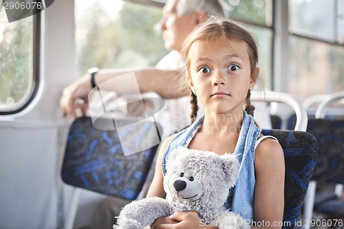 Image of Funny open eyed girl in a tram