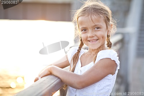 Image of Happy young girl in a city