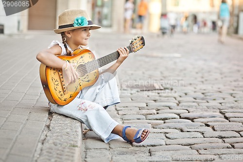 Image of Girl playing guitar on the street