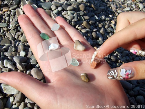 Image of Multi-coloured pebble and glass on a female palm