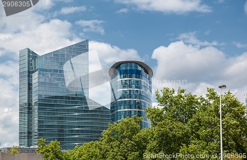 Image of Modern building near park with green trees