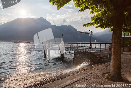 Image of View of Como lake on sunset with pier in Italy