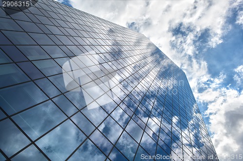 Image of Skyscraper with reflection of blue sky and clouds