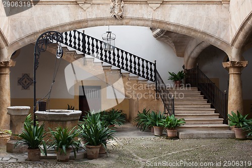 Image of Cozy european patio with well and stairs