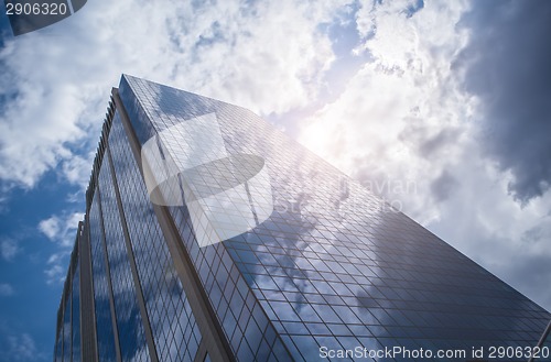 Image of Skyscraper with reflection of blue sky and clouds