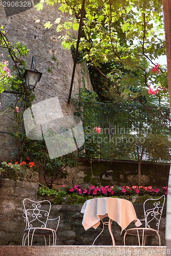 Image of table and chairs in italian garden