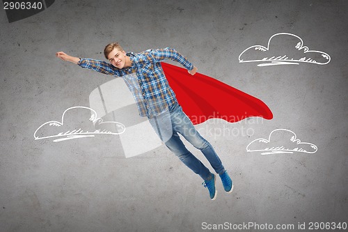 Image of smiling young man jumping in air