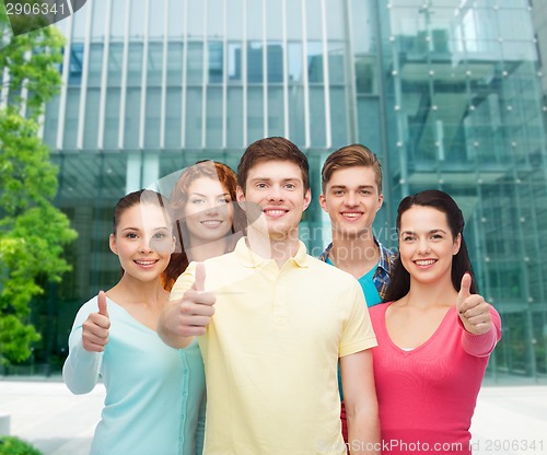 Image of group of smiling teenagers over city background