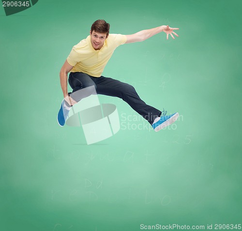 Image of smiling young man jumping in air